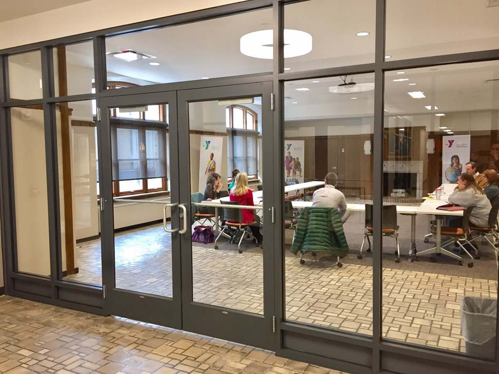 Large conference room with a group of people meeting inside. Custom hollow metal doors and hollow metal frames supplied by LaForce Inc.